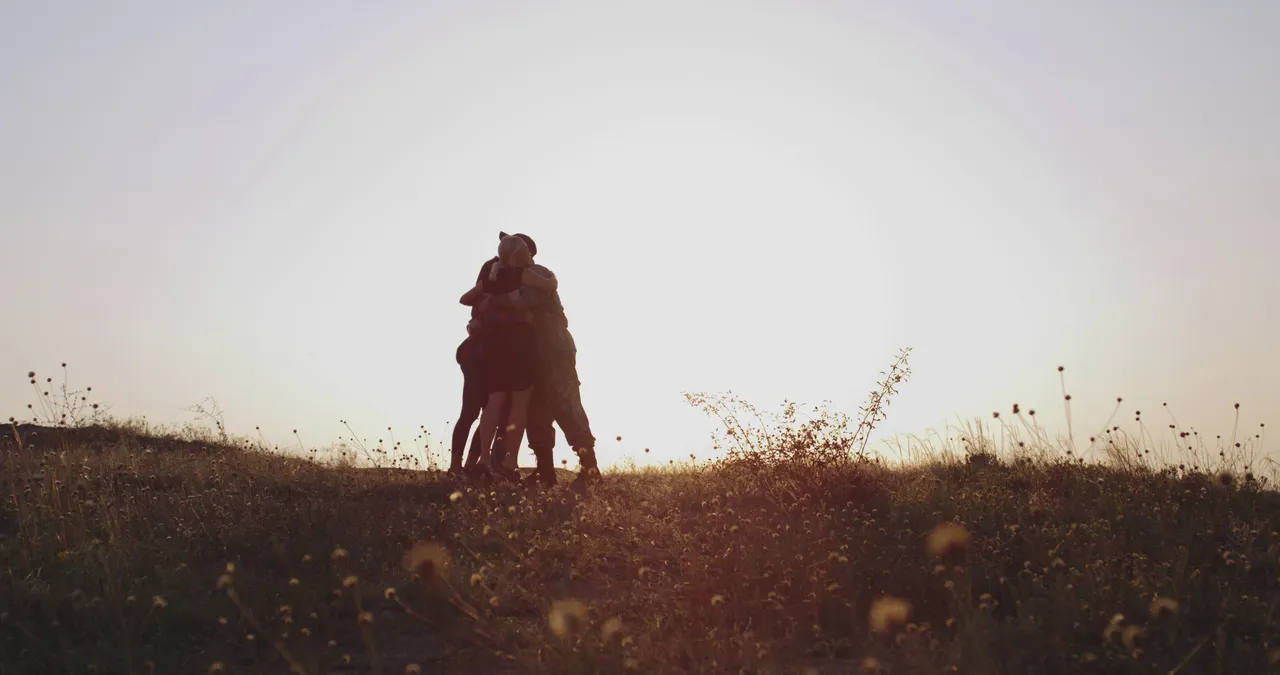 Military family silhouette at sunset